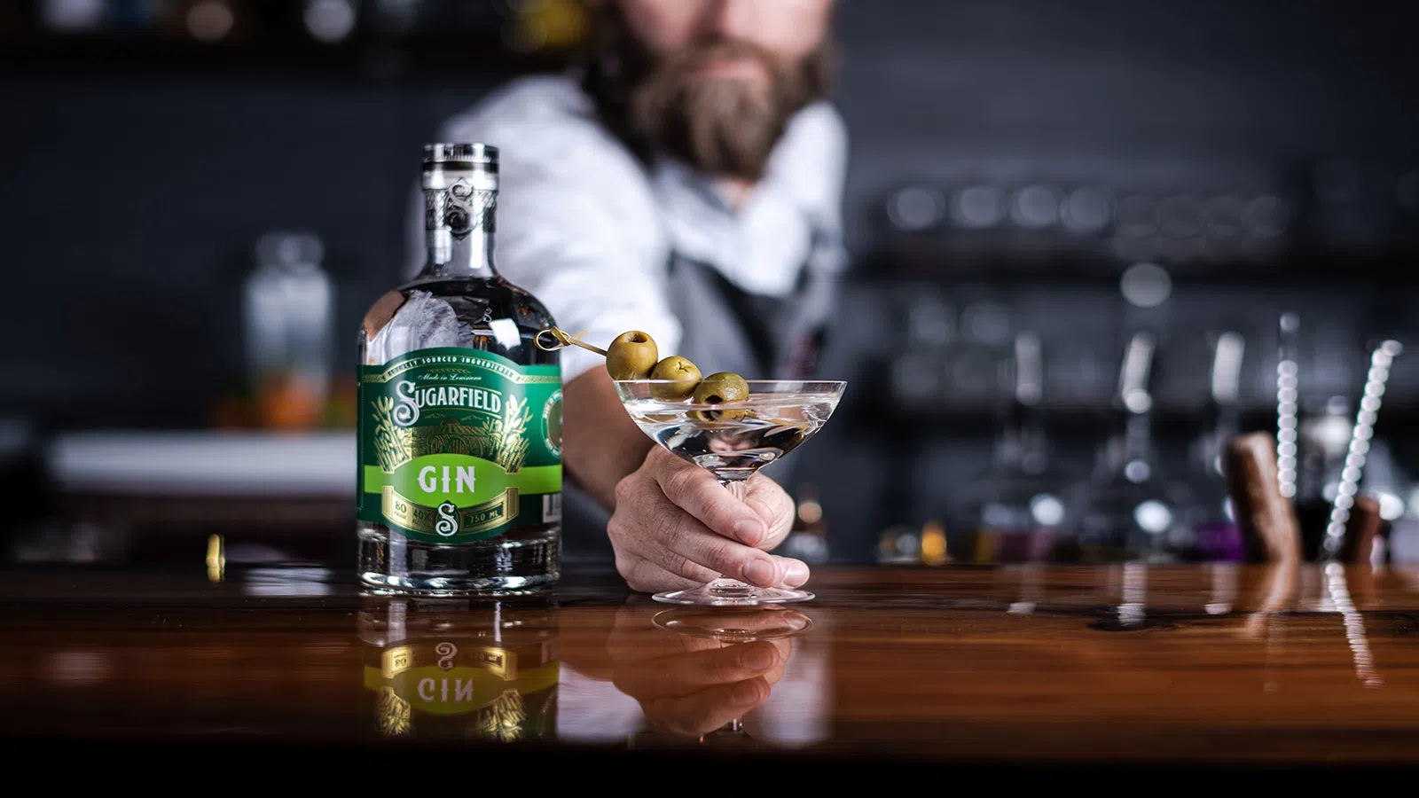 a person pouring a drink into a glass bottle