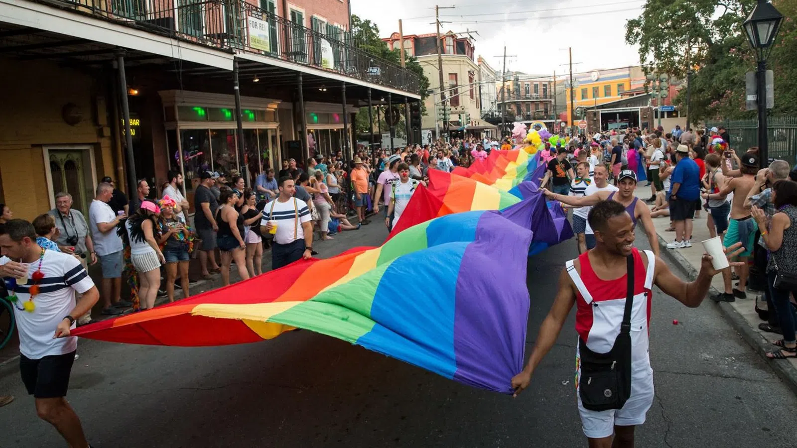 a person running with a rainbow flag
