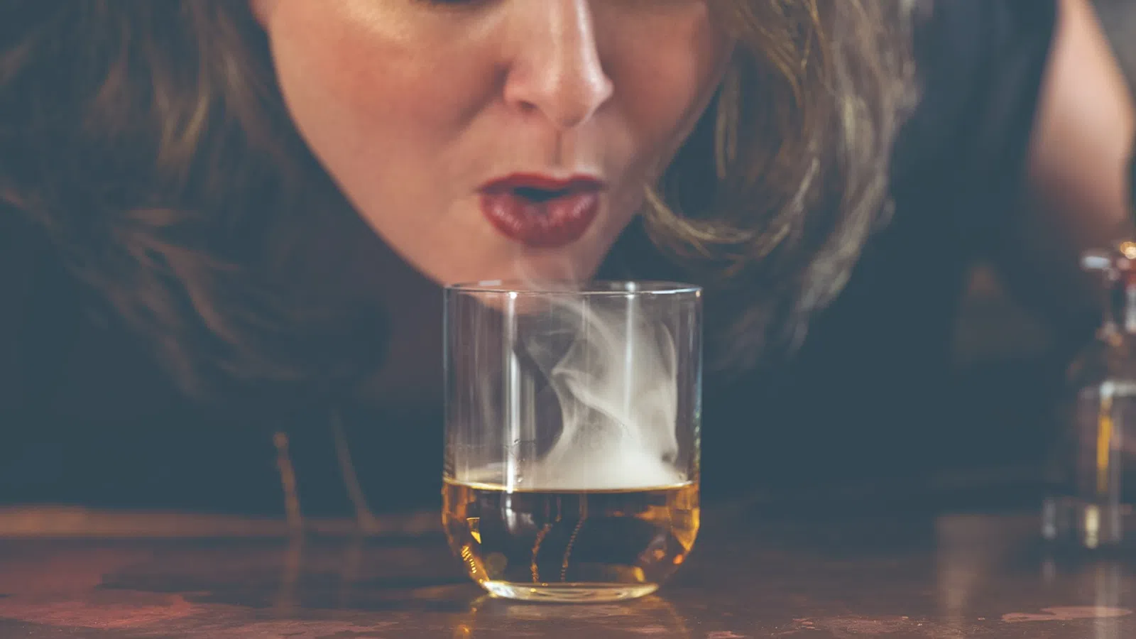 a person drinking from a glass