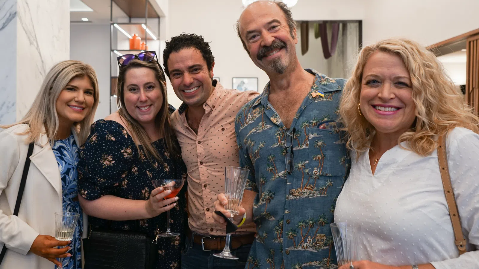 a group of people holding wine glasses