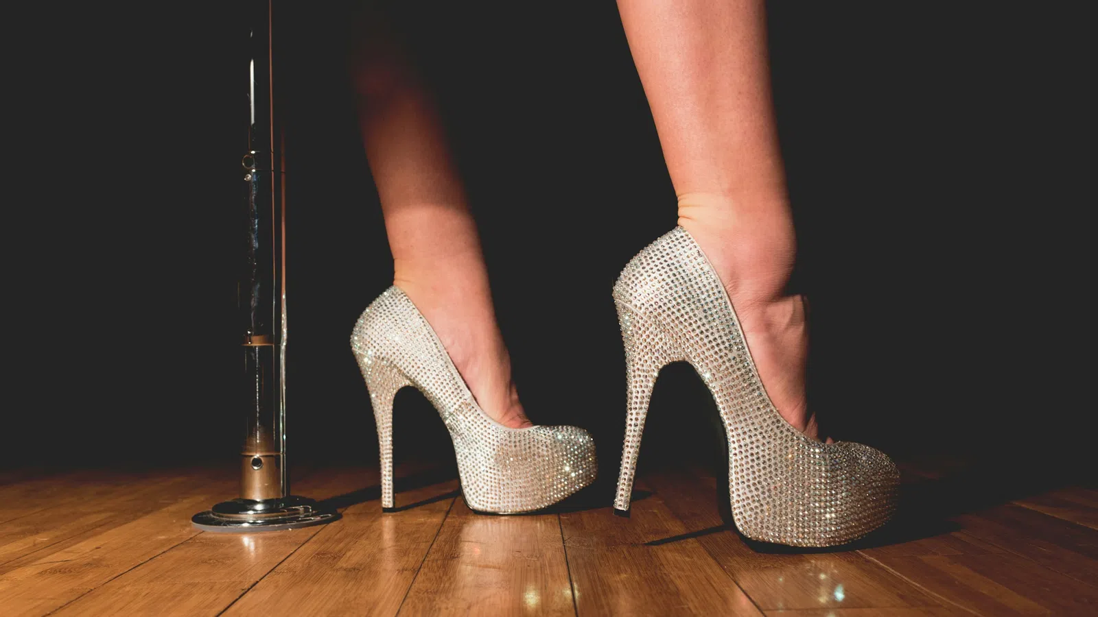 a pair of feet wearing high heeled shoes