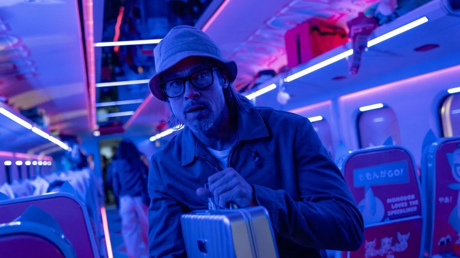 a man with a cigarette in his mouth and a suitcase in a bus