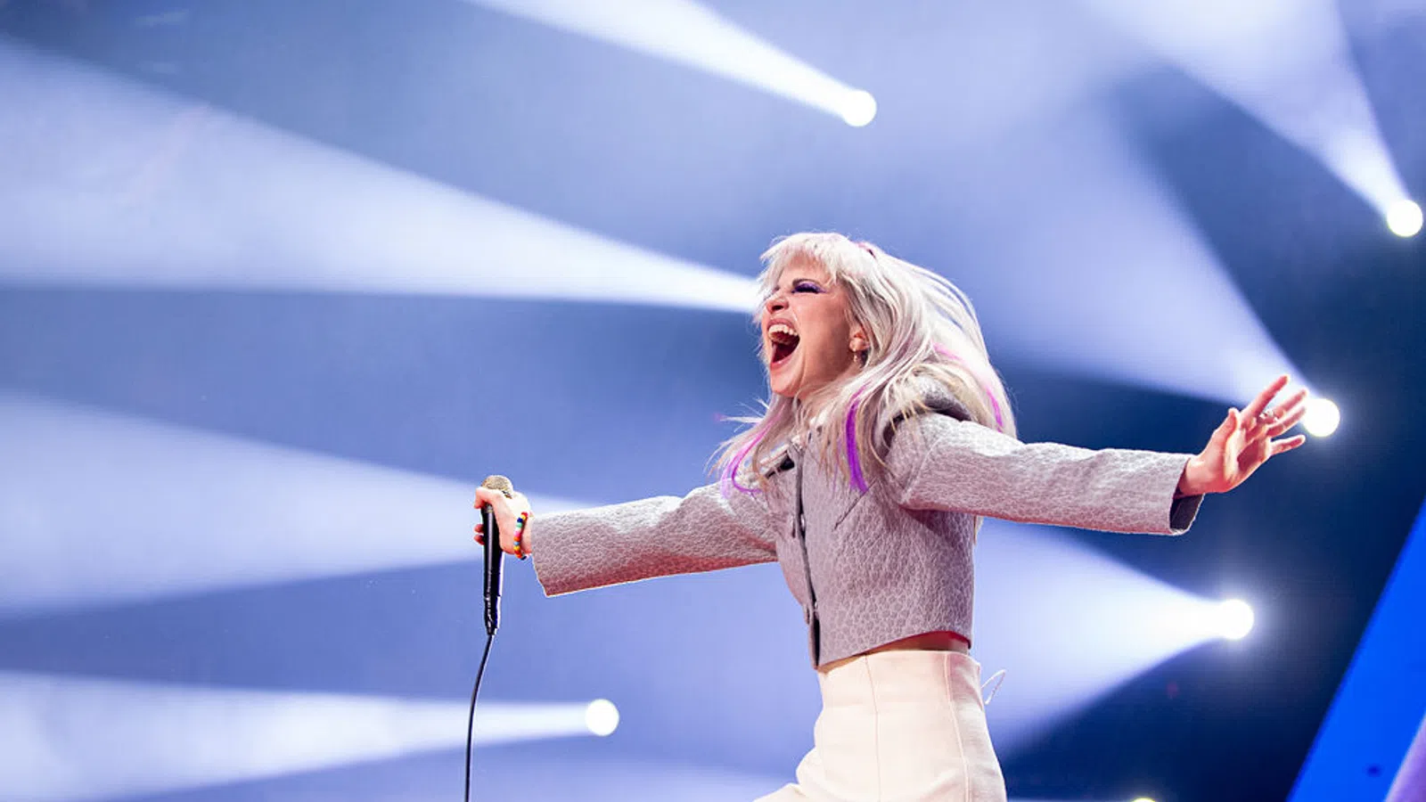a woman singing into a microphone