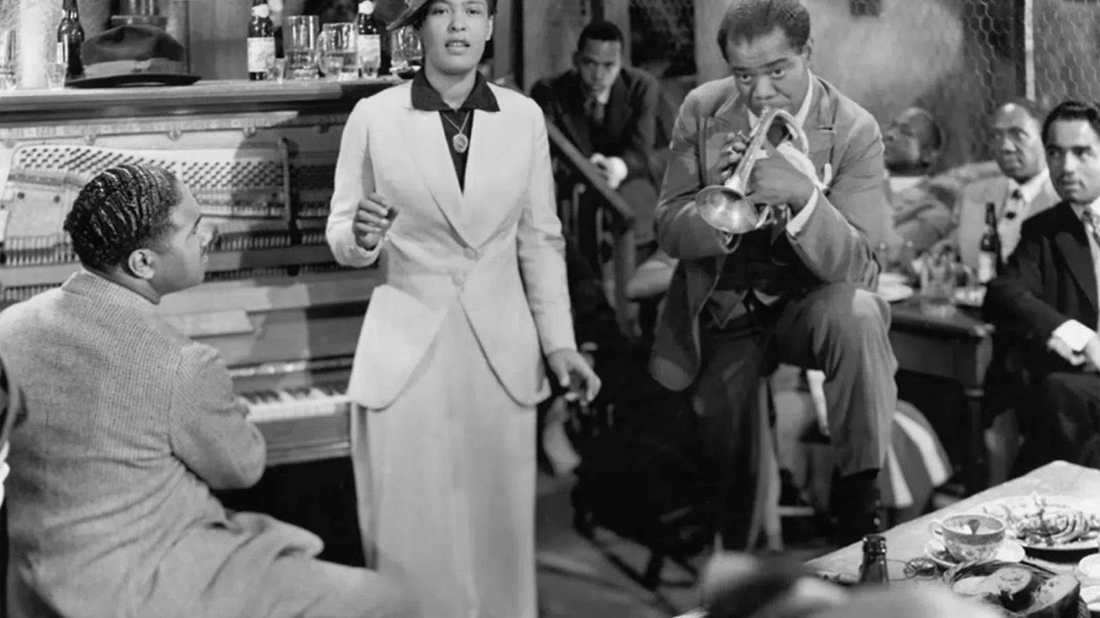 Louis Armstrong pouring a drink into a glass