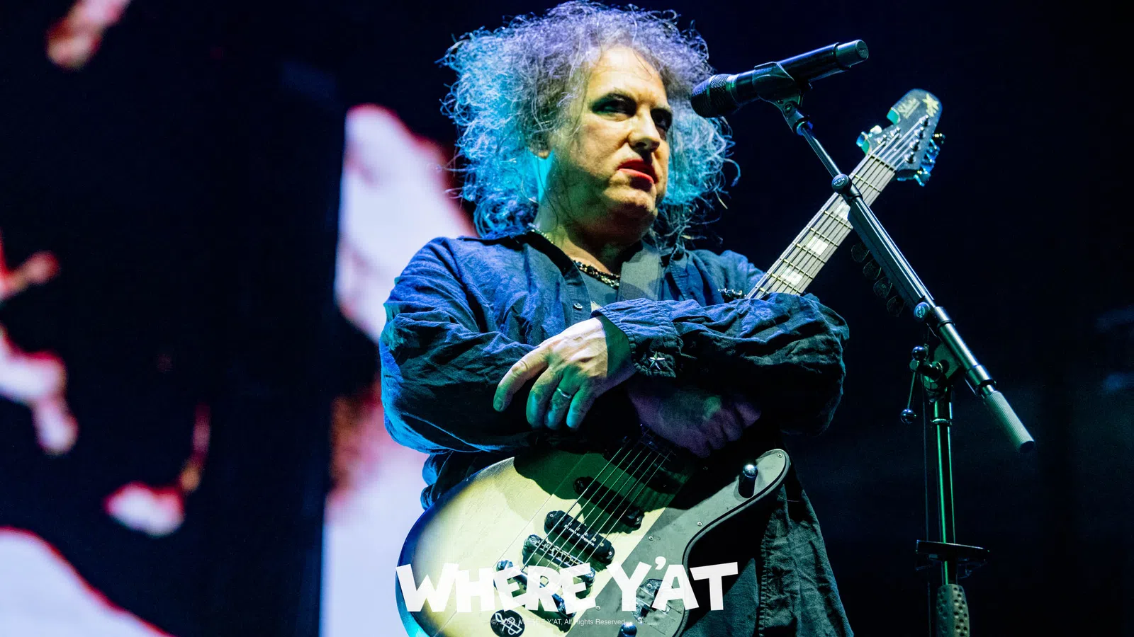 Robert Smith playing a guitar