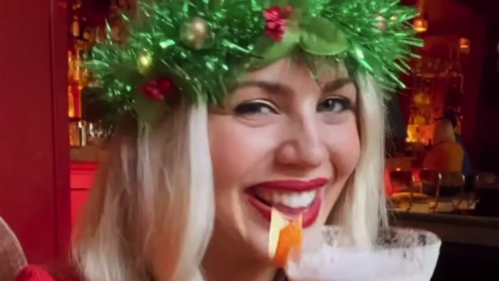 a person with a christmas tree in the background