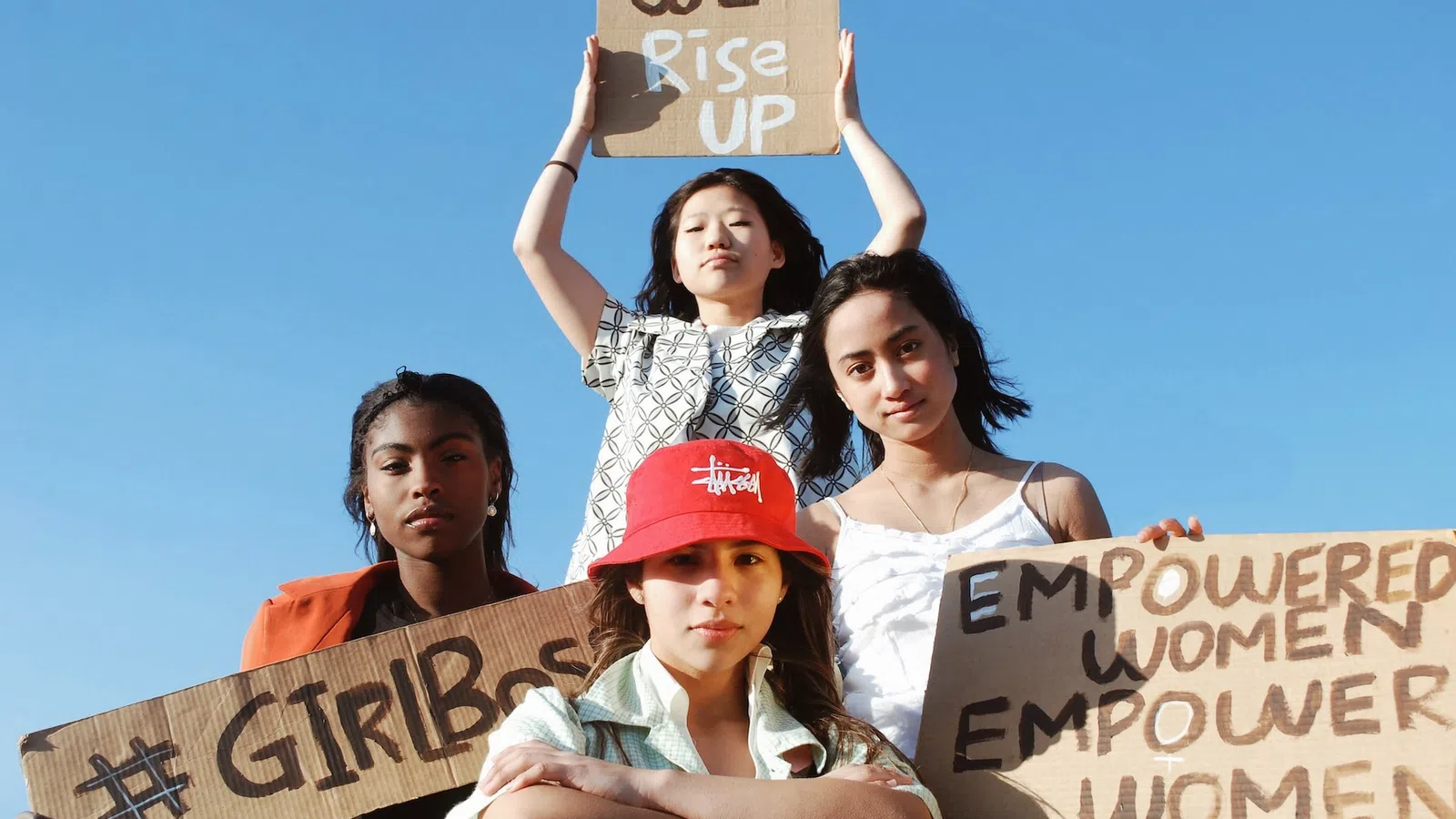 a group of women holding signs
