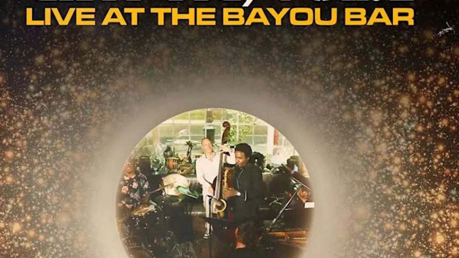 Live jazz performance at Bayou Bar with musicians playing double bass, drums, and piano in a vibrant atmosphere.
