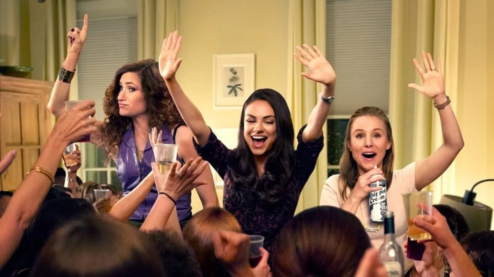 a group of women raising their hands