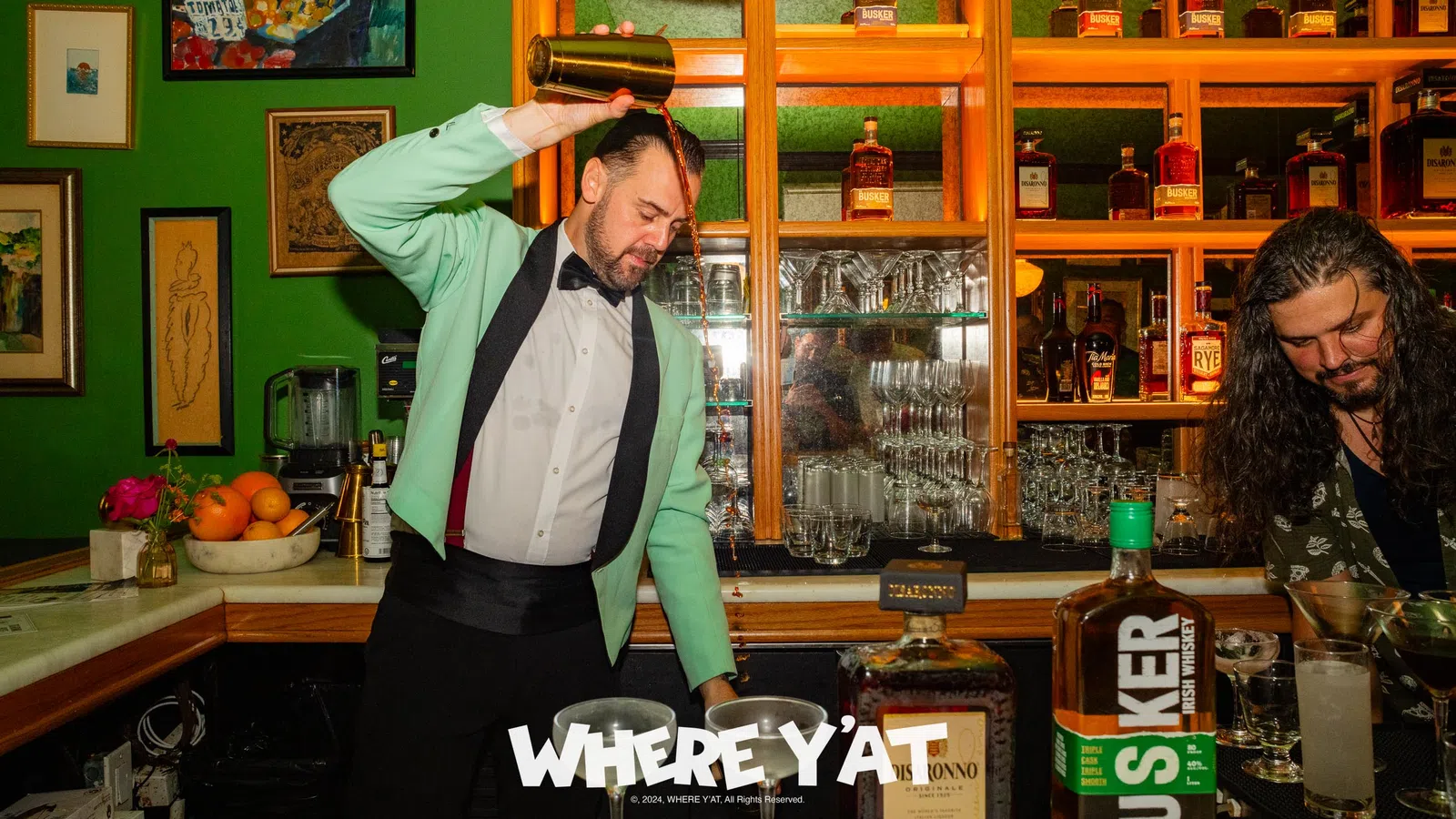 a man standing behind a bar