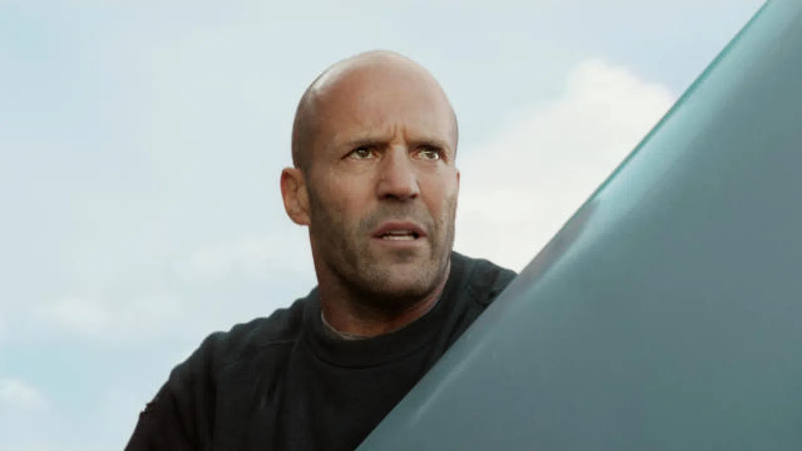 Jason Statham in a black shirt