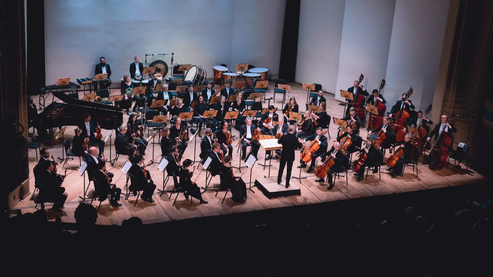a group of people playing instruments on a stage