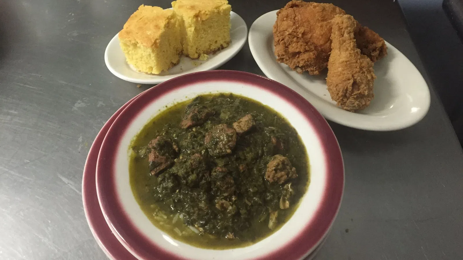 a bowl of soup next to plates of food