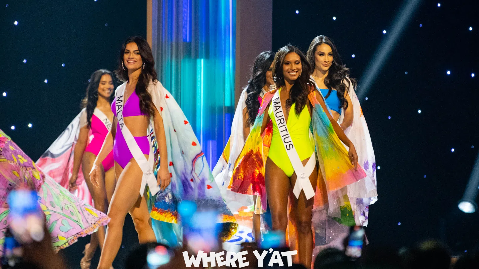 a group of women in colorful dresses