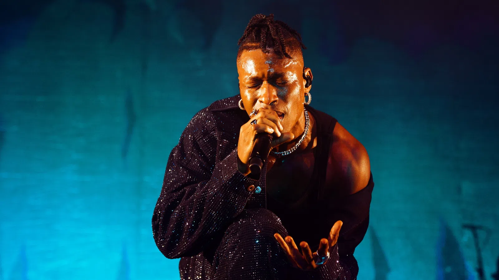 a man singing into a microphone