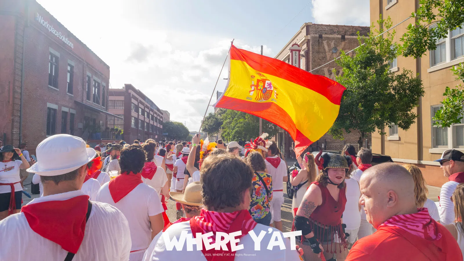 a group of people walking down a street holding a flag