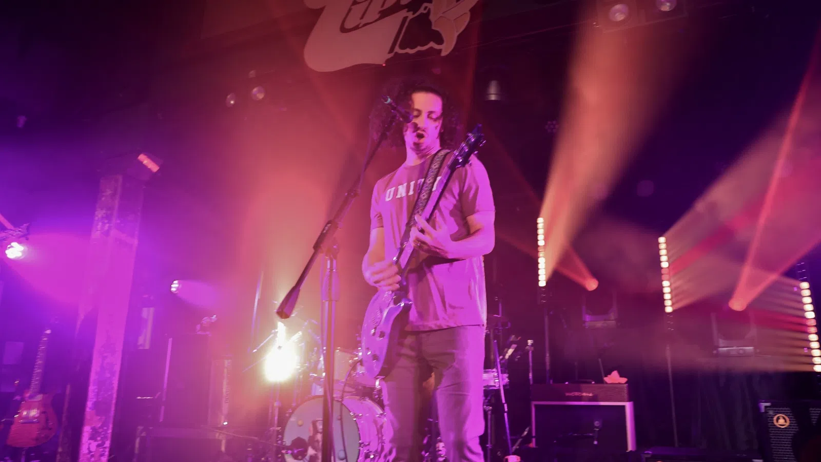 a person playing a guitar on a stage