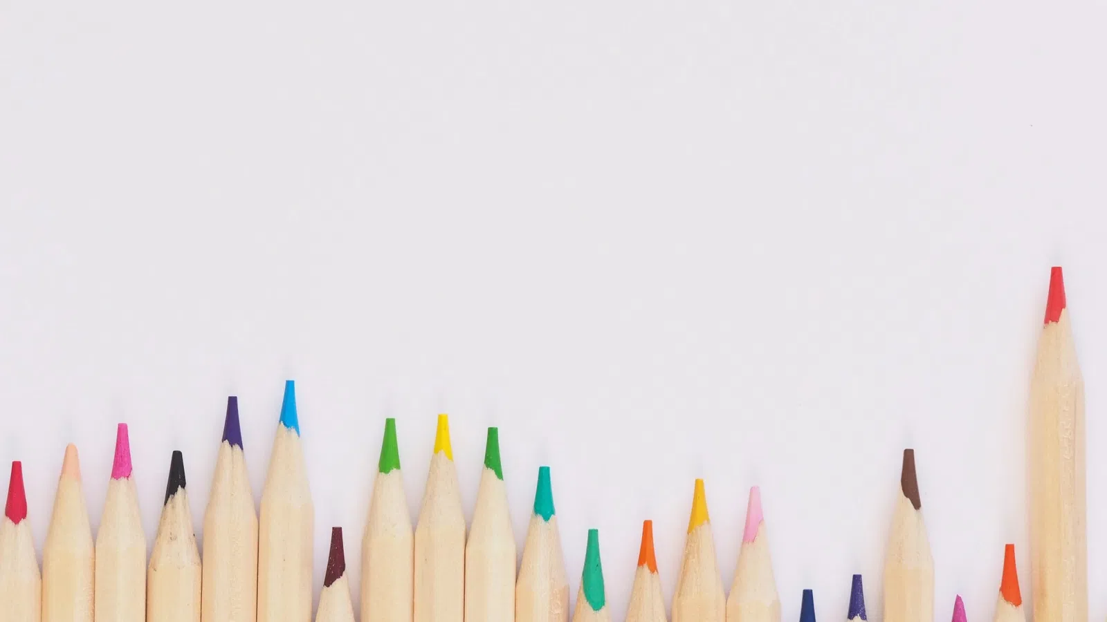 a group of colored pencils