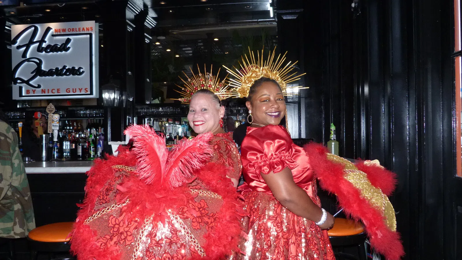 two women wearing red dresses