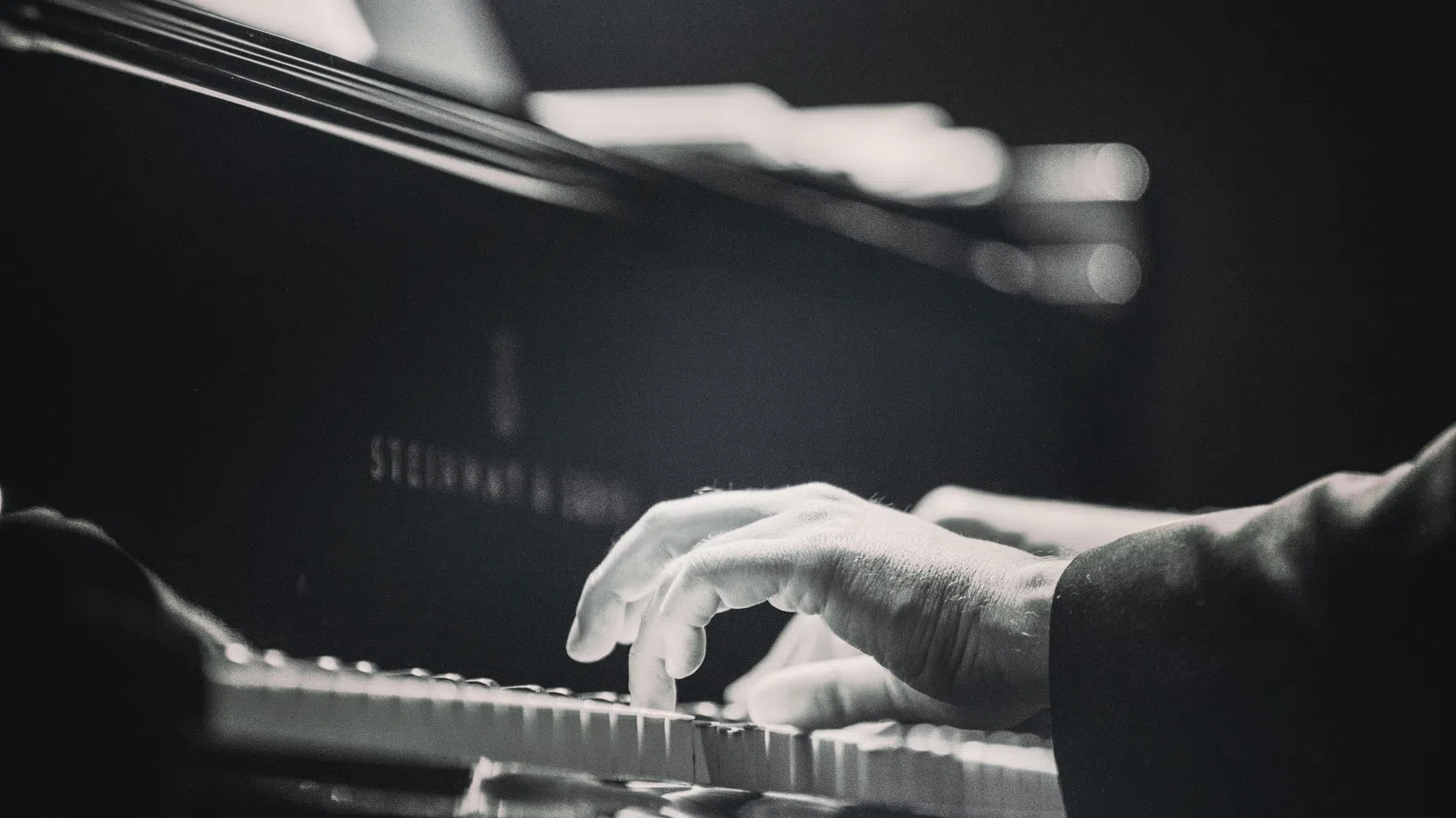 close-up of hands playing piano