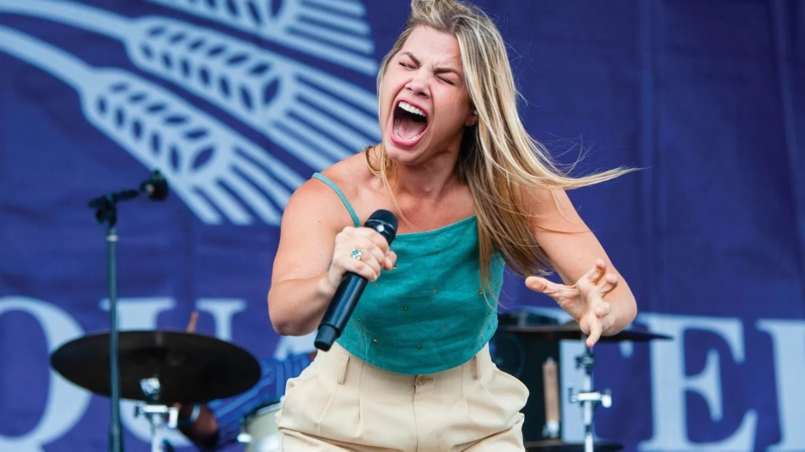 a woman singing into a microphone