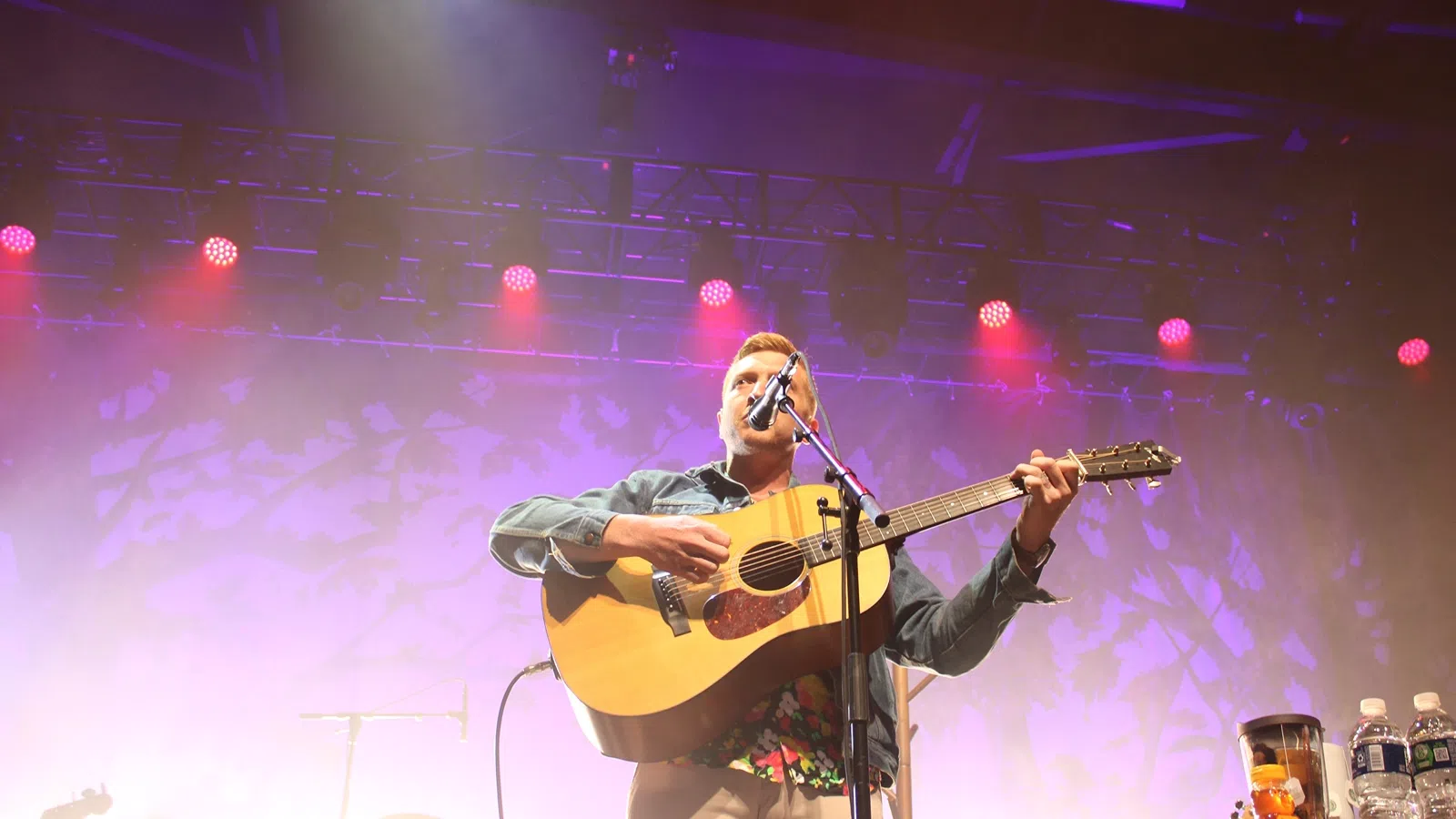 a person playing a guitar on a stage