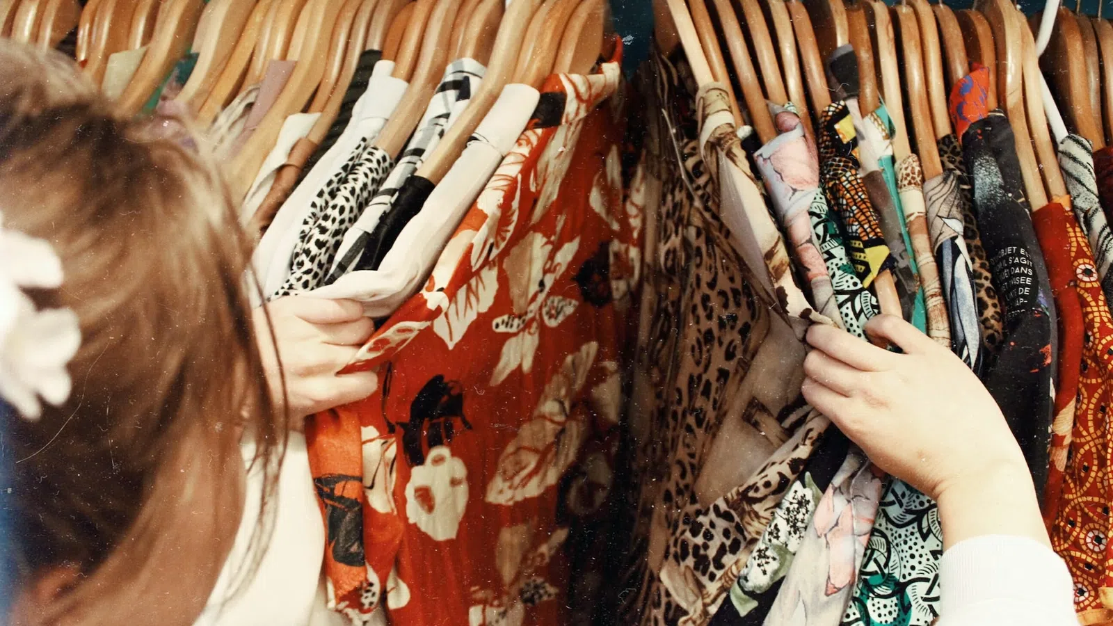 a person looking at a bunch of ties