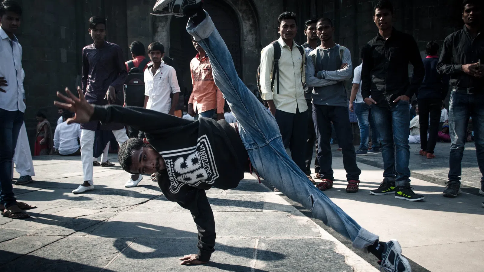 a person doing a handstand on a sidewalk