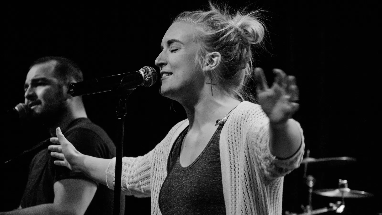 a woman singing into a microphone