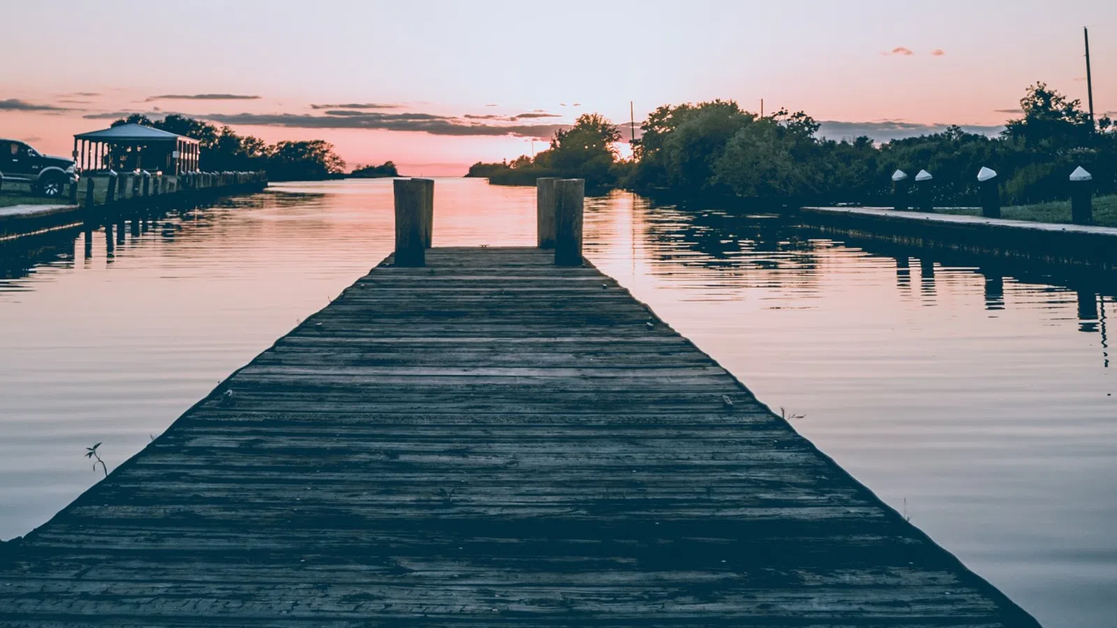 a dock with a boat in the water