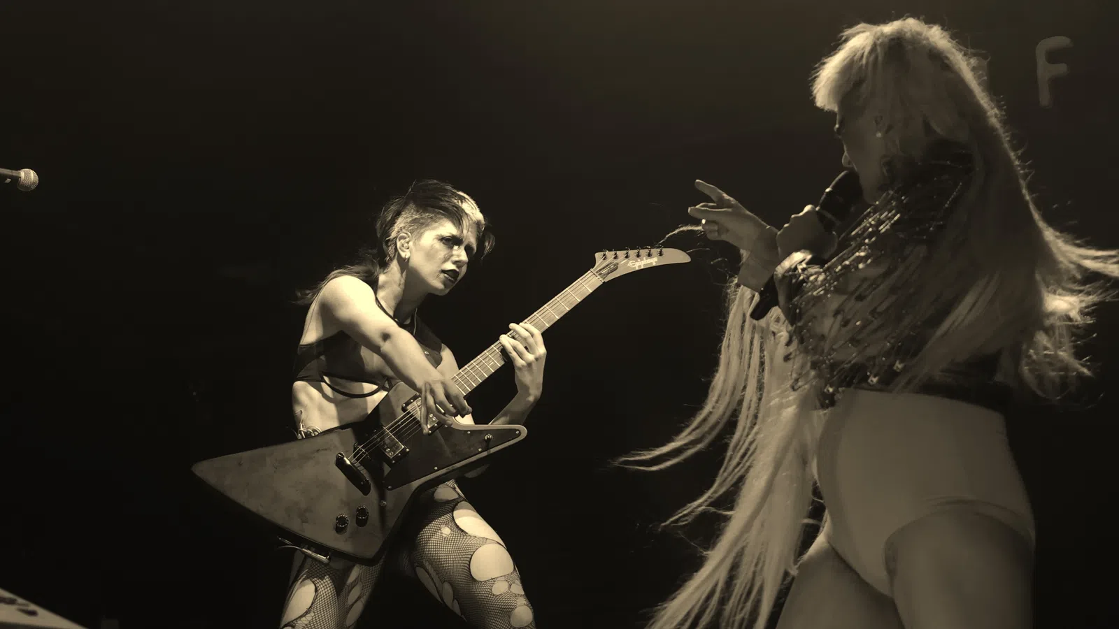 a couple of women playing guitars