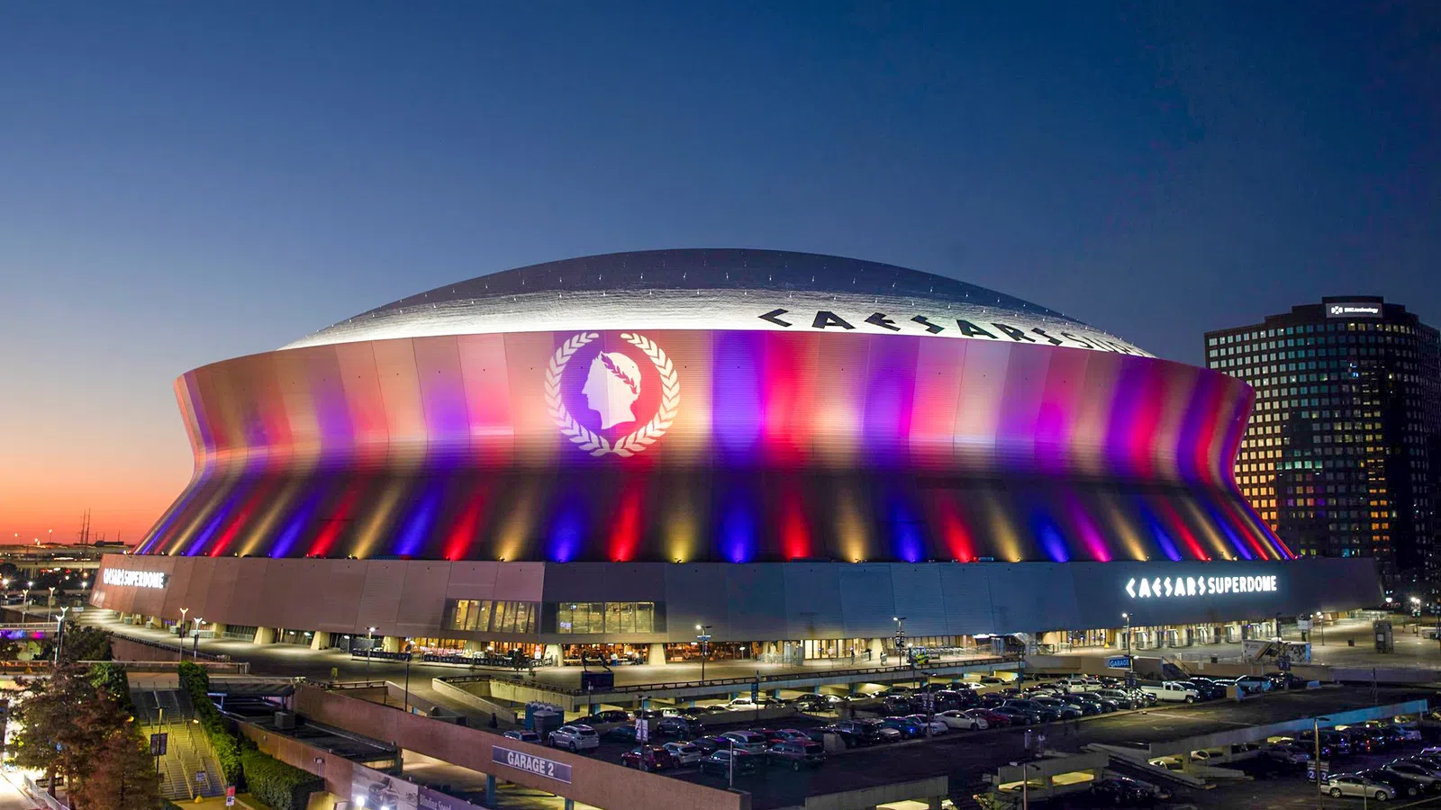 a stadium with a large roof with Mercedes-Benz Superdome in the background
