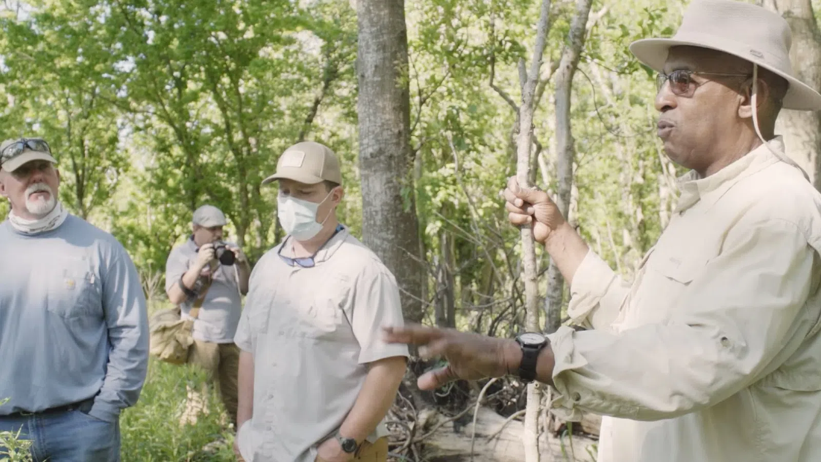 a group of men in a forest