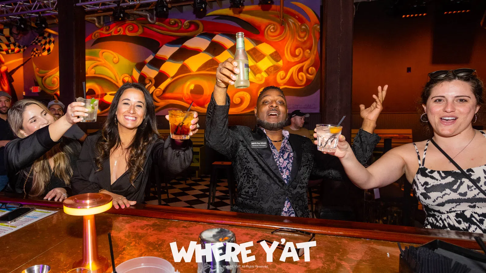 a group of people sitting at a table with drinks