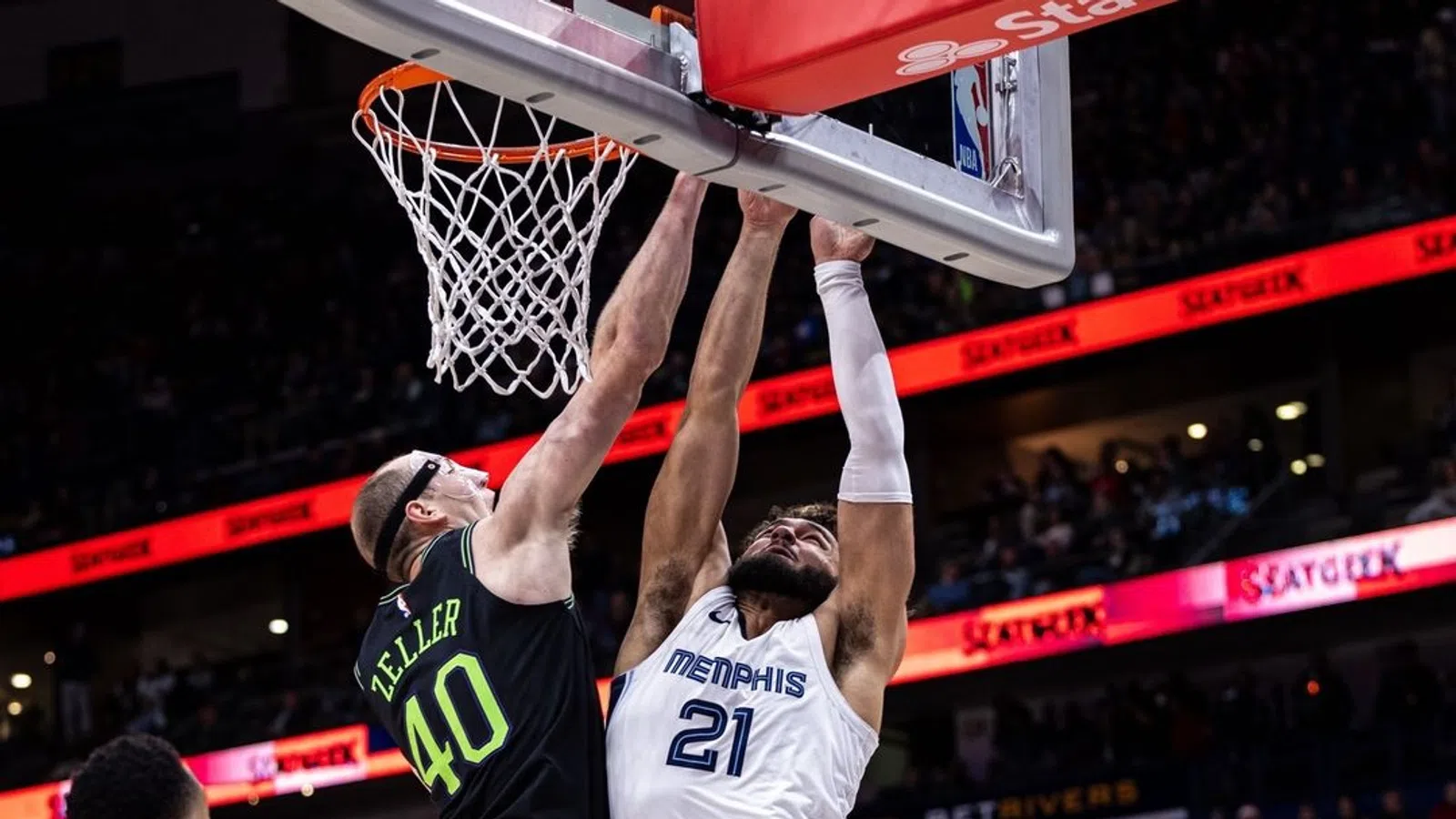 a basketball player jumping to dunk a basketball