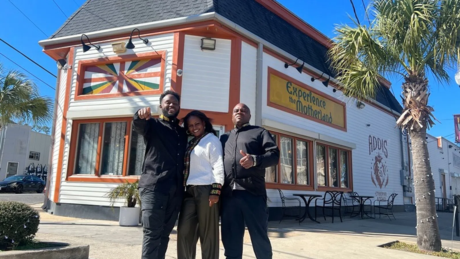 a group of people posing for a photo in front of a restaurant