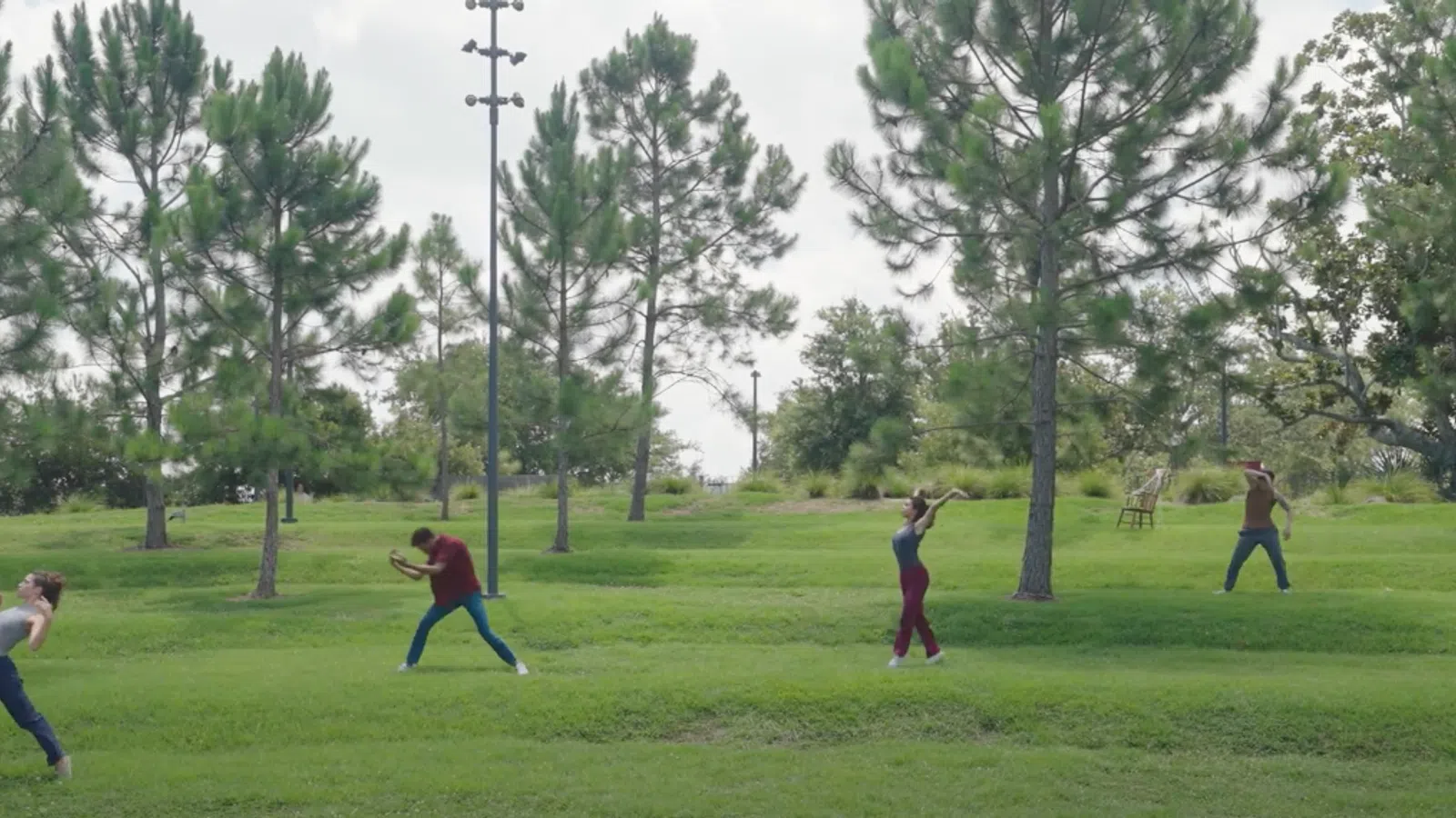 a group of people playing baseball