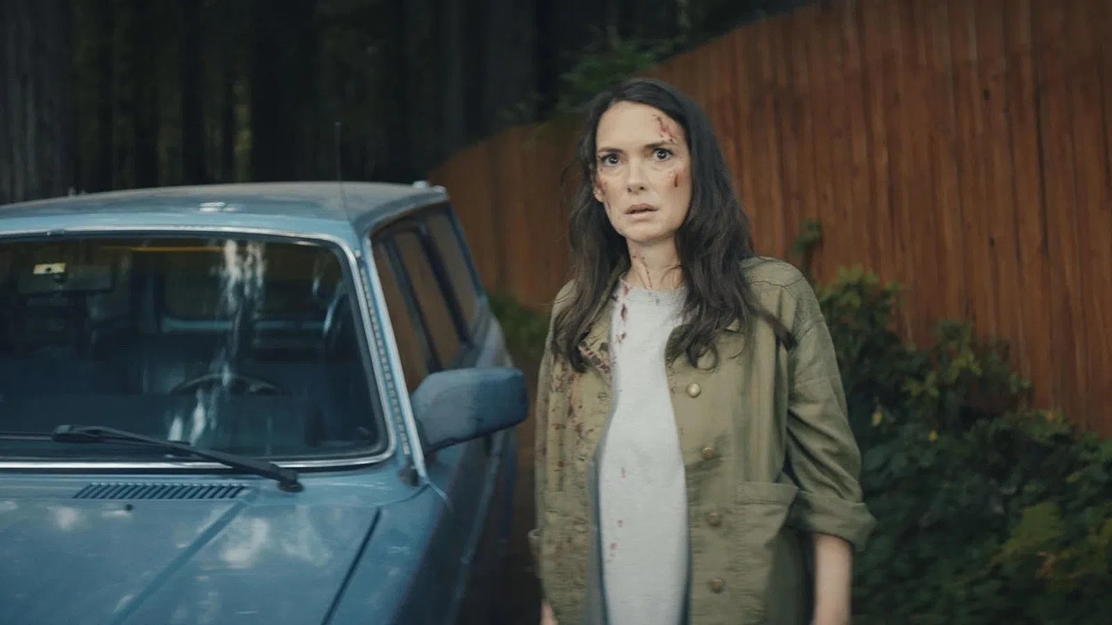 a person standing next to a car
