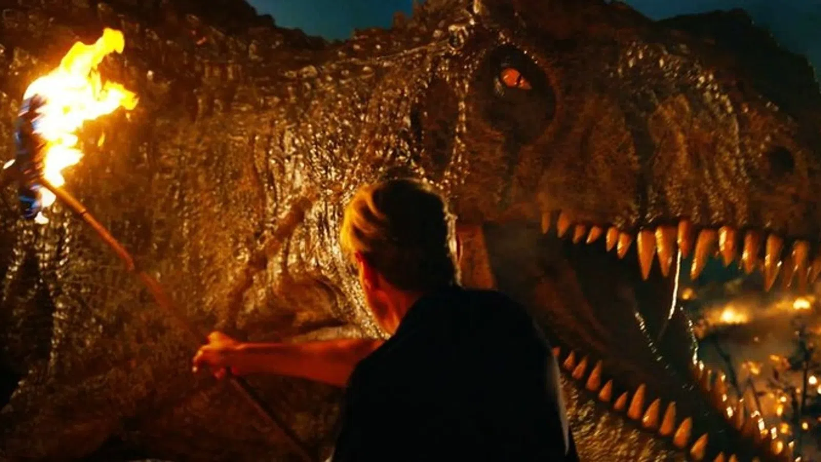 a person standing next to a dinosaur