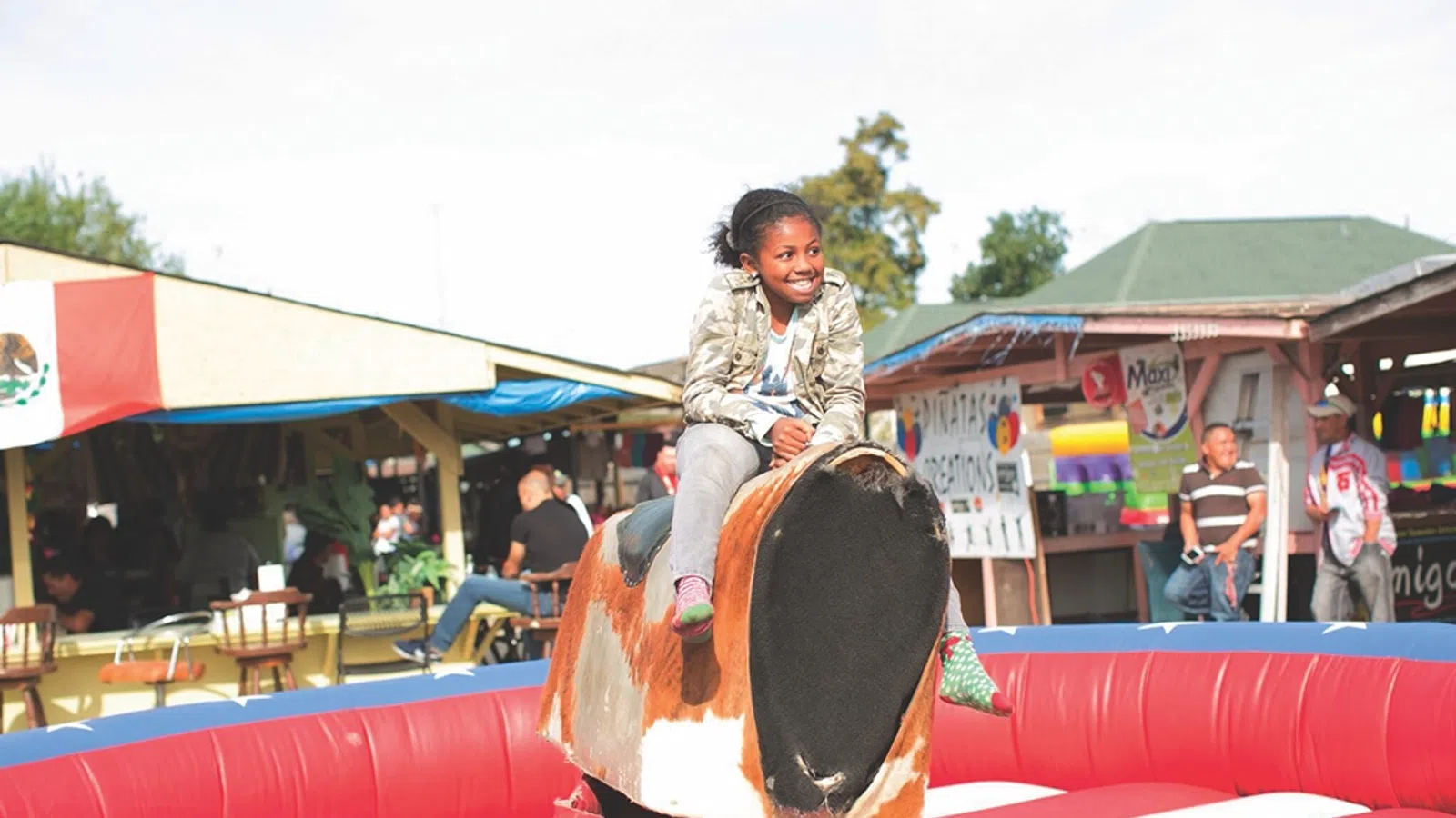 a girl sitting on a large red and black object