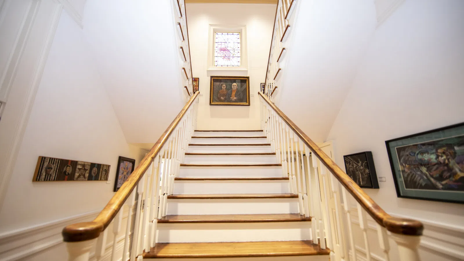 a staircase with pictures on the wall