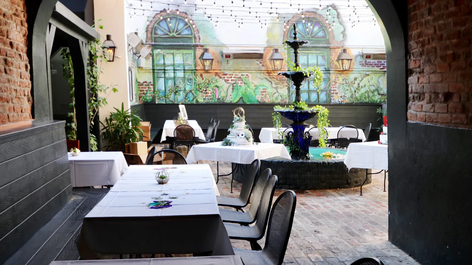 a courtyard with tables and chairs