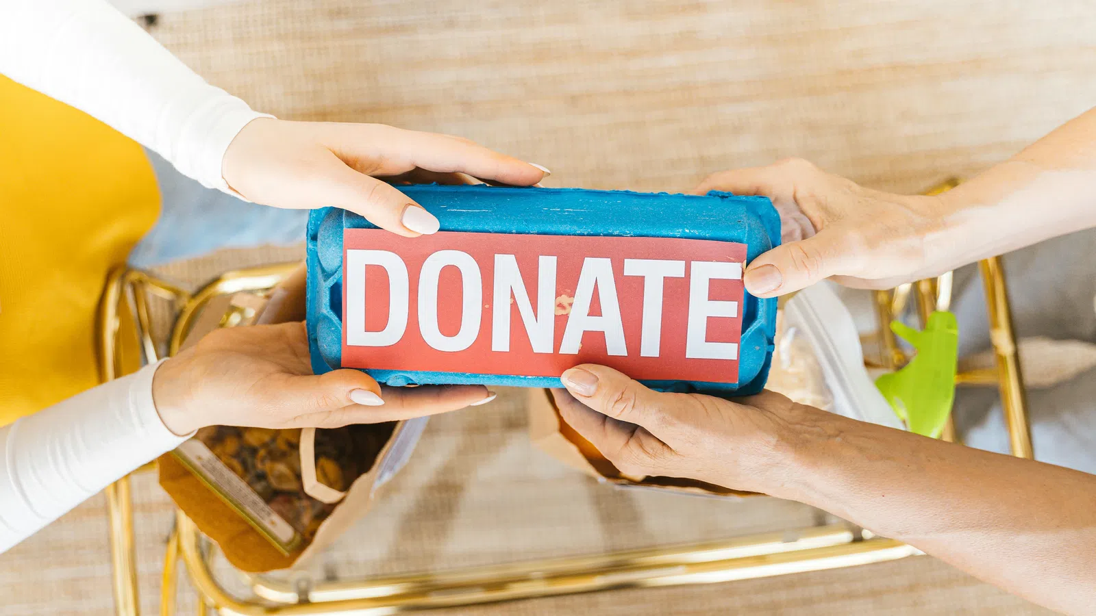 a close-up of hands holding a blue container