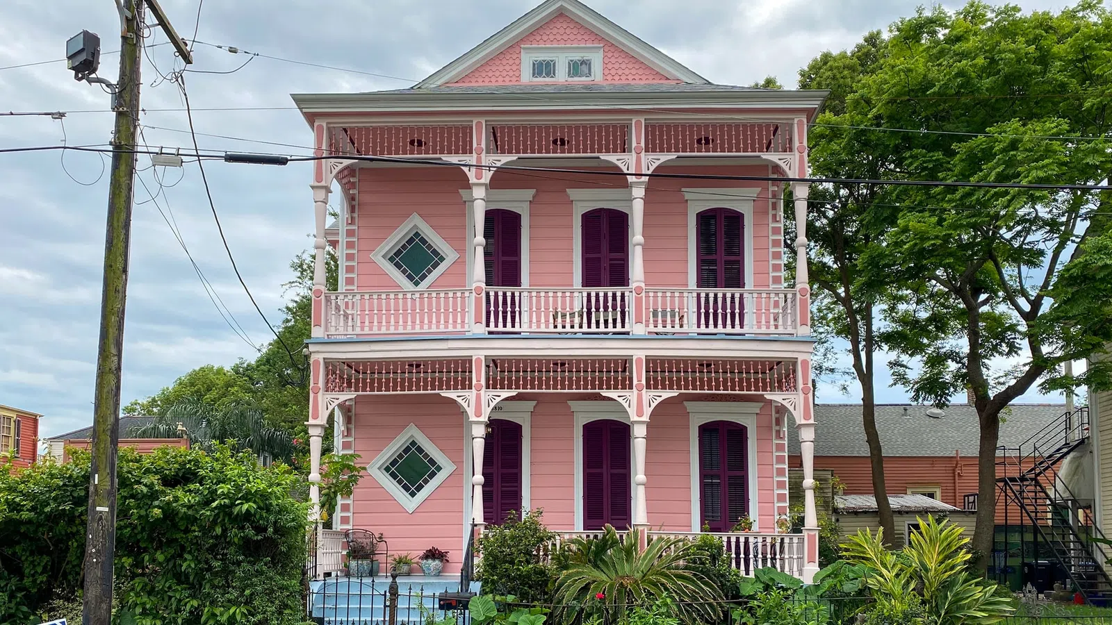 a pink house with a blue fence