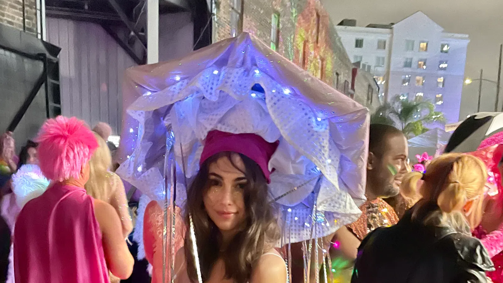 a person in a graduation gown holding an umbrella