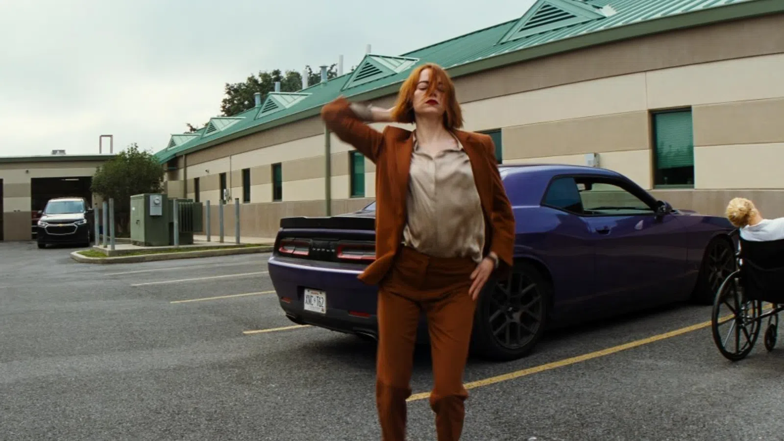 a woman in a brown jacket