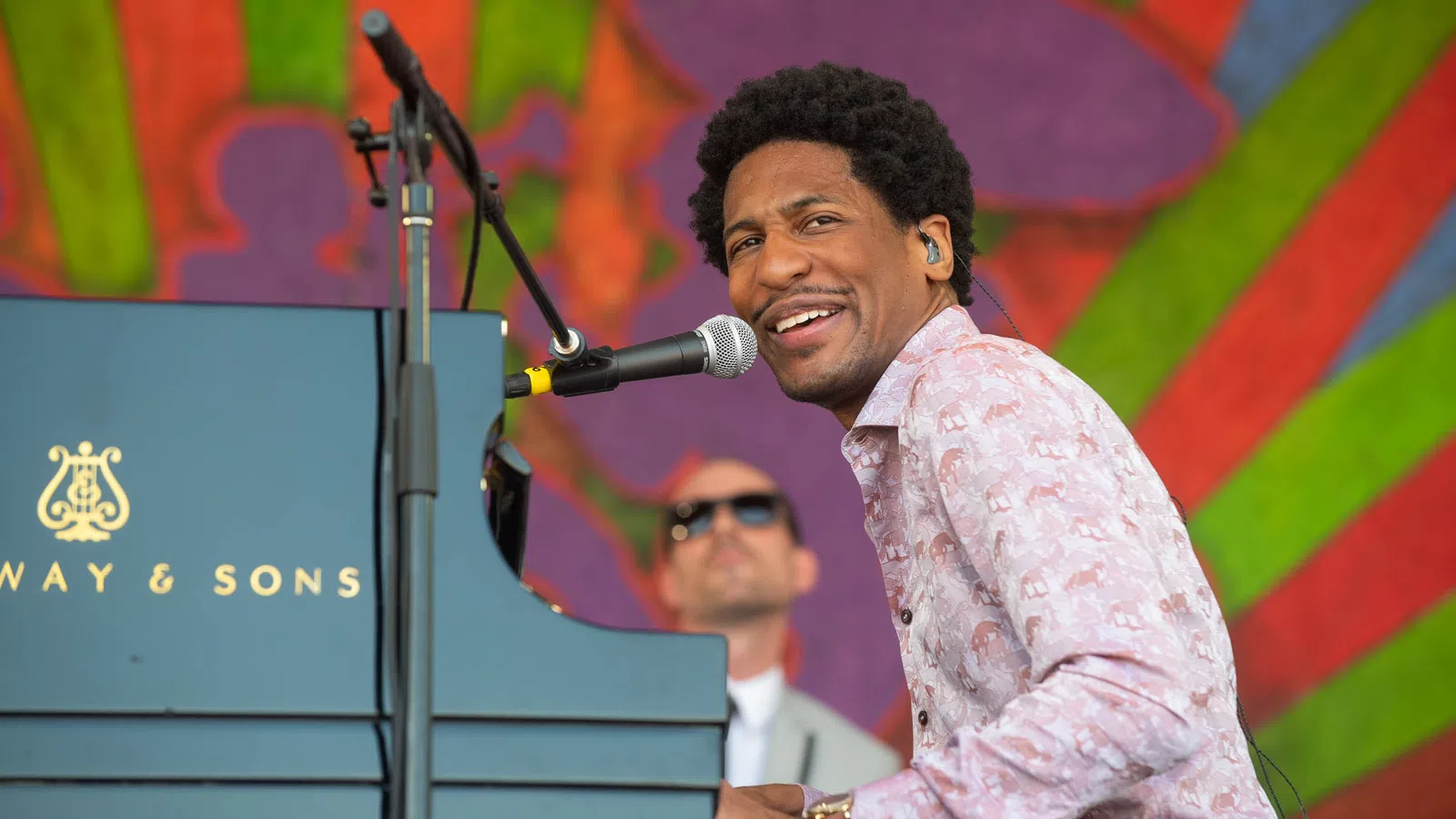 Jonathan Batiste smiling at a podium