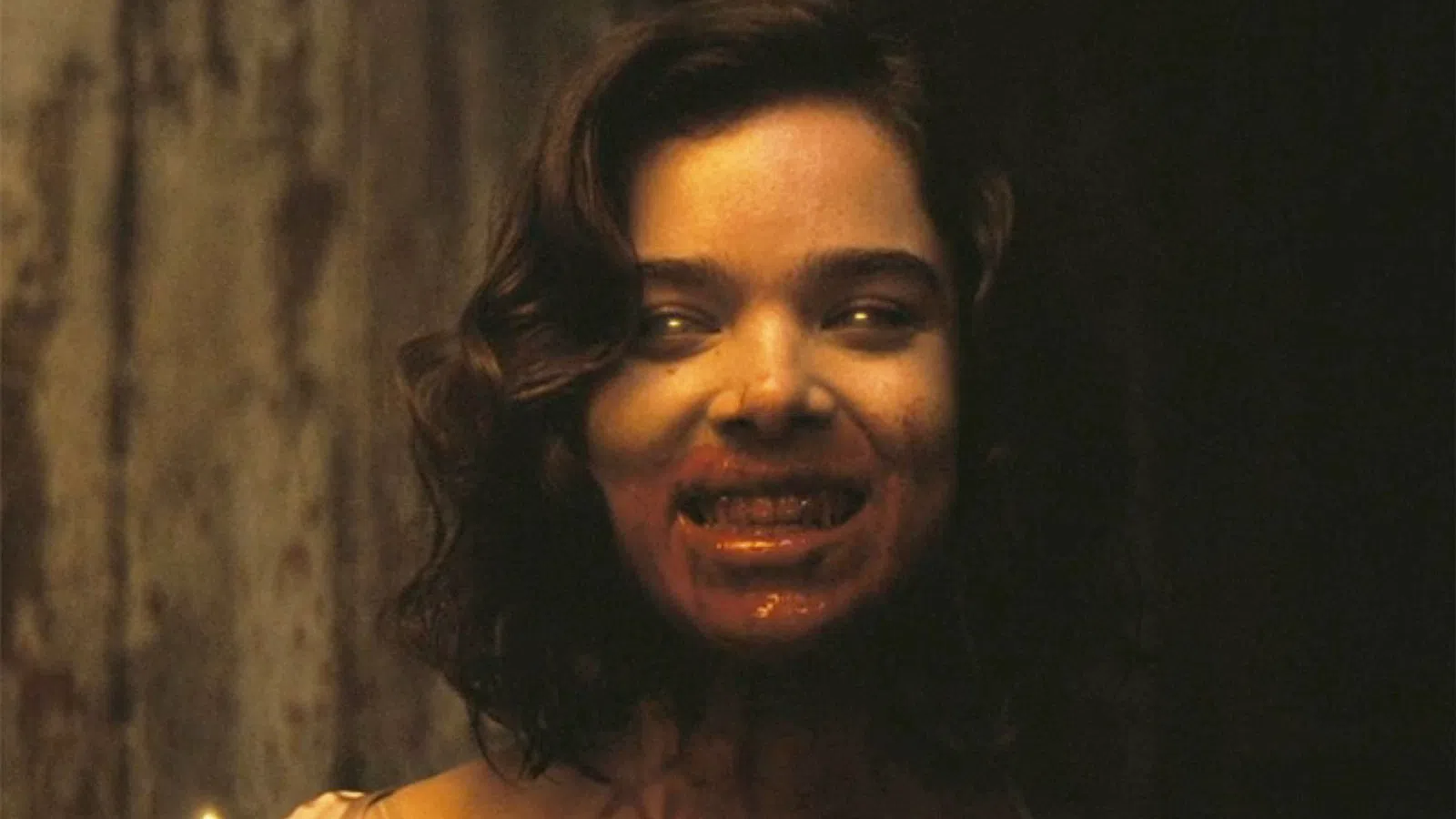 A woman with a sinister smile and blood on her face in a dark setting, evoking horror and suspense.
