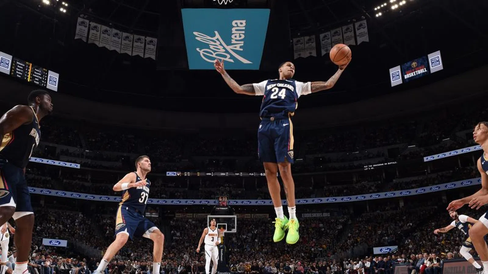 a basketball player jumping to dunk a basketball
