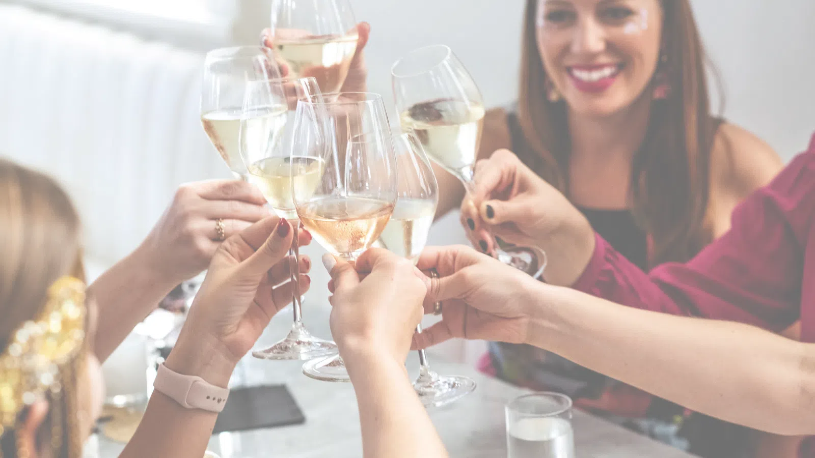 a group of people holding wine glasses